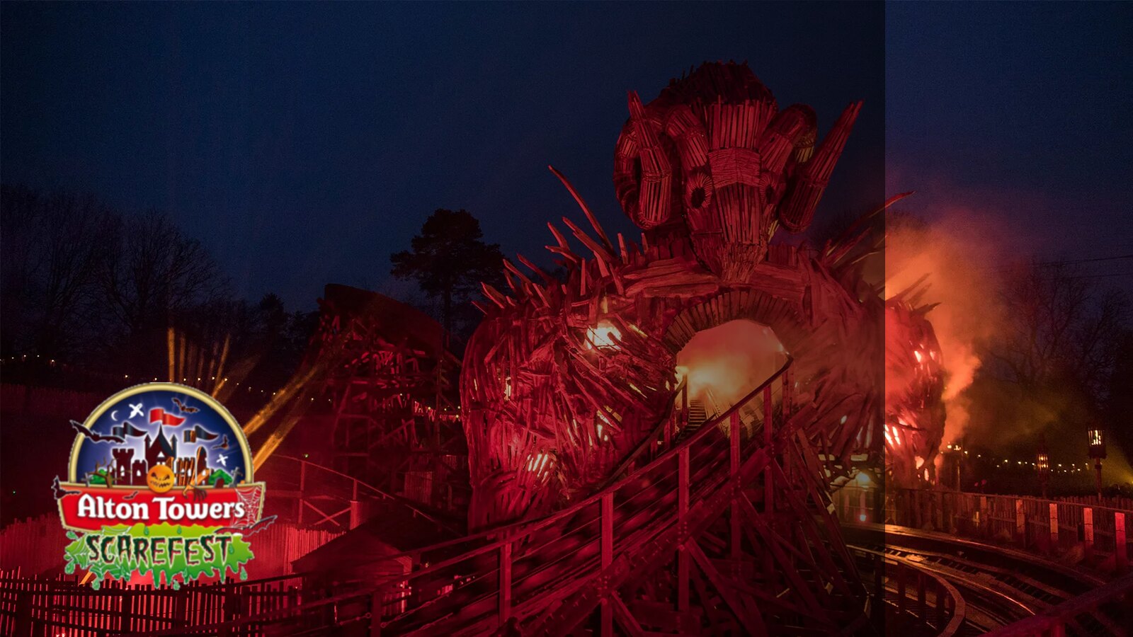 The Wicker Man at Alton Towers lit red against a dusk sky during Scarefest, with the Alton Towers Scarefest logo